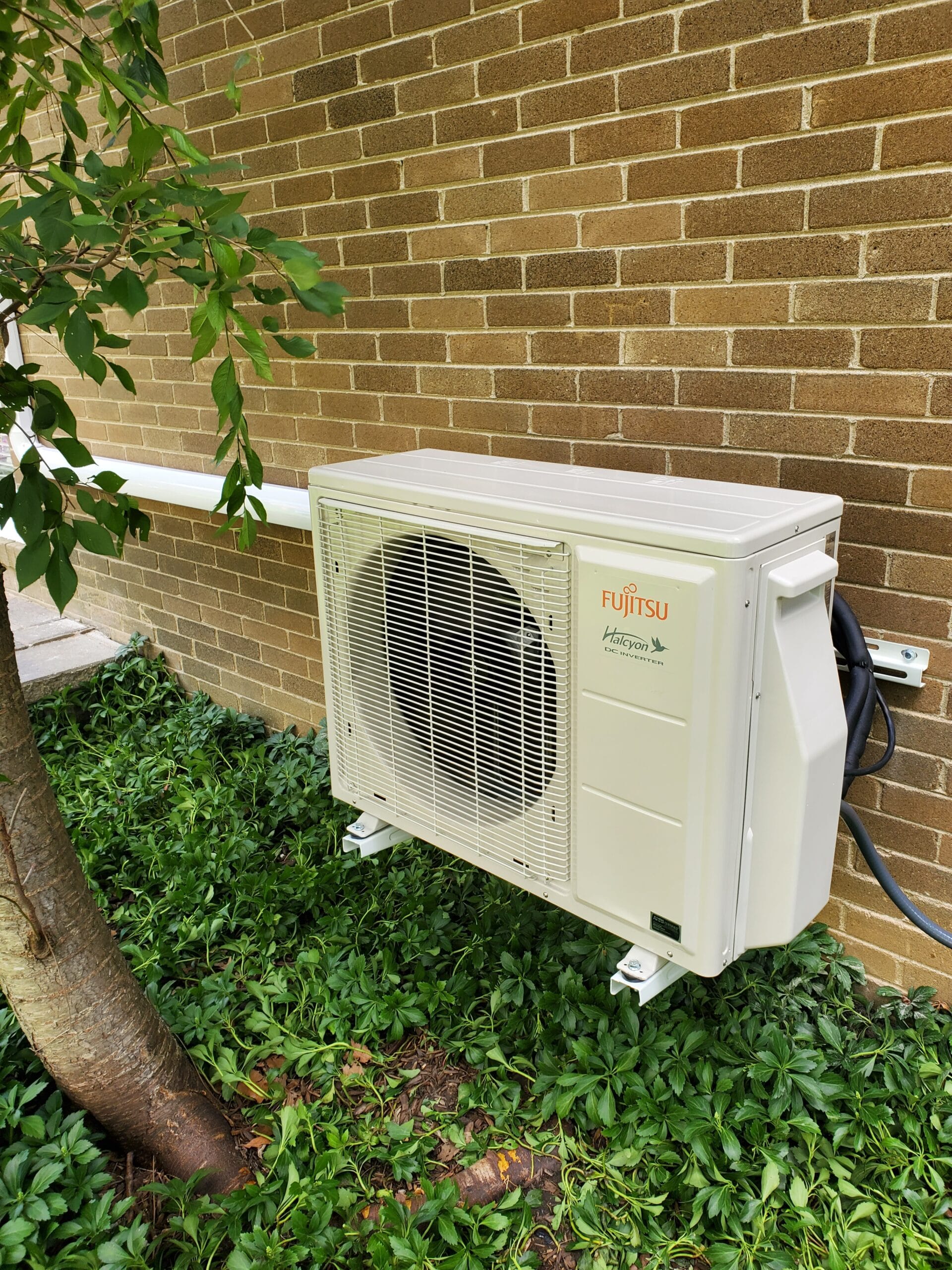 Exterior portion of a Fujitsu mini-split heating and air conditioning system. Also known as a heat pump.